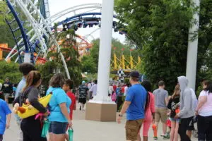 park visitors and roller coaster going upside down